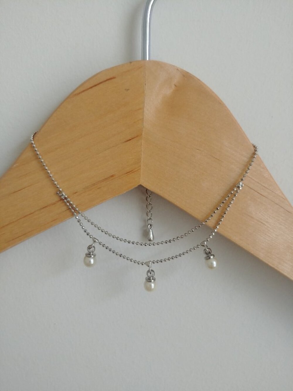 Dainty silver tone dangle bracelet with three pearl look drops